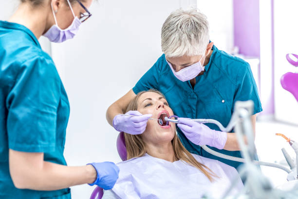 istock Woman Dentist with patient 1037614416
