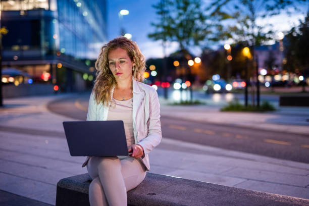 istock Beautiful woman using laptop outdoor. 1037619188