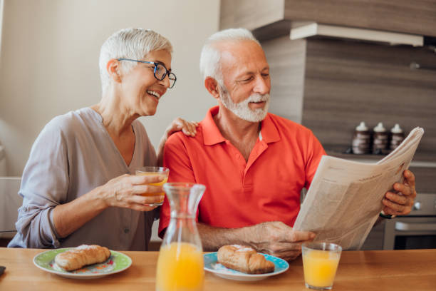 istock Senior couple having breakfast and reading newspapers 1037623288