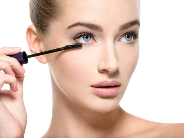 istock Girl makes makeup. Woman apply mascara on eyelashes 1037624972