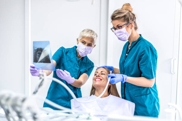 istock Woman at Dentist with patient 1037627132