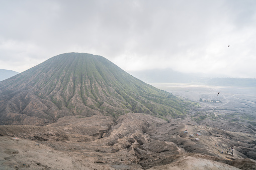 Famous Ijen volcano crater and acidic lake panoramic view during colorful sunrise in East Java