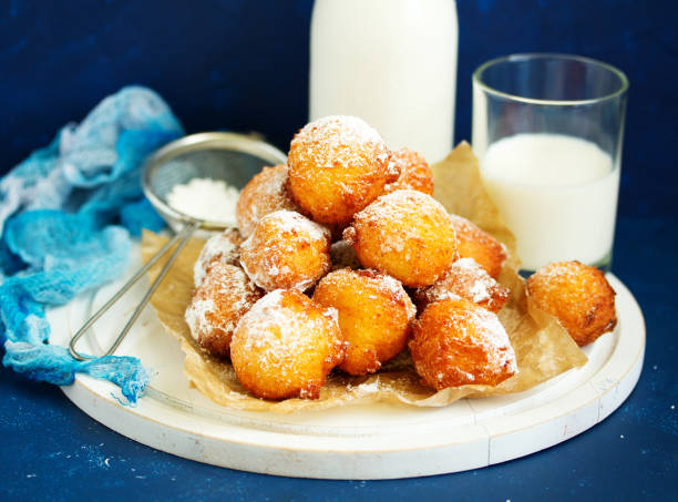 istock Small donuts without a filling in powdered sugar. 1037629886