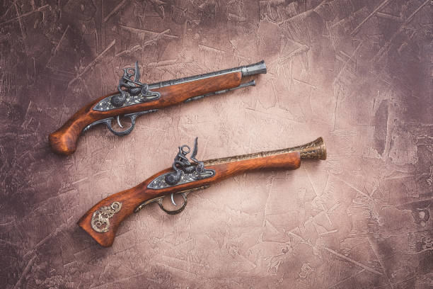 istock Two vintage duel pistols on wooden background 1037630748