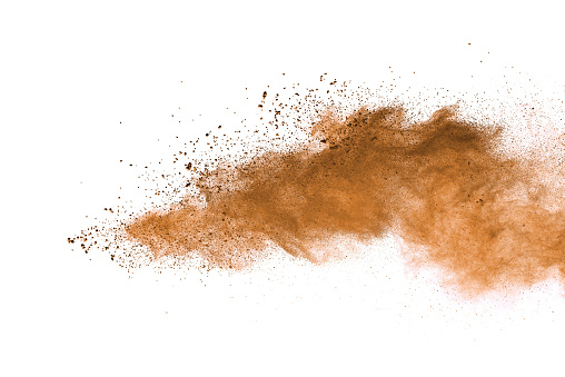 Abstract brown colored soil splash on white background. Color dust explode on background by throwing freeze stop motion.