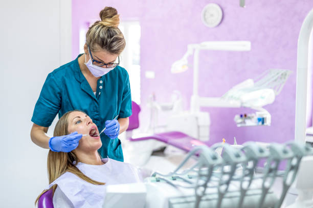 istock Woman at Dentist with patient 1037640058