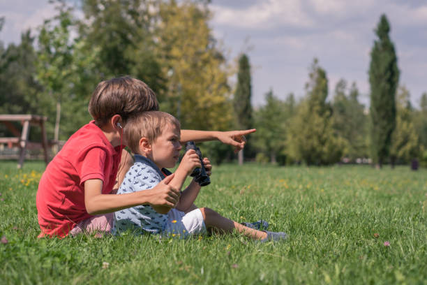 istock Happy brother looks through the binoculars 1037642964
