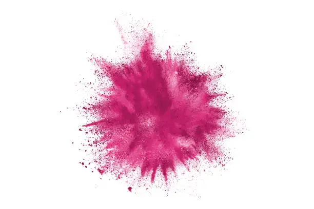 Purple powder explosion. The particles of charcoal splatter on white background. Closeup of colored dust particles splash isolated on background.