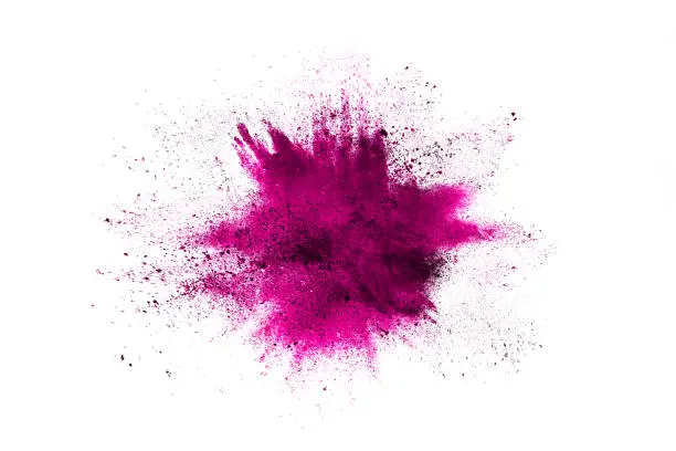 Photo of Purple powder explosion. The particles of charcoal splatter on white background. Closeup of colored dust particles splash isolated on background.