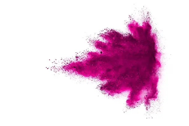 Photo of Purple powder explosion. The particles of charcoal splatter on white background. Closeup of colored dust particles splash isolated on background.