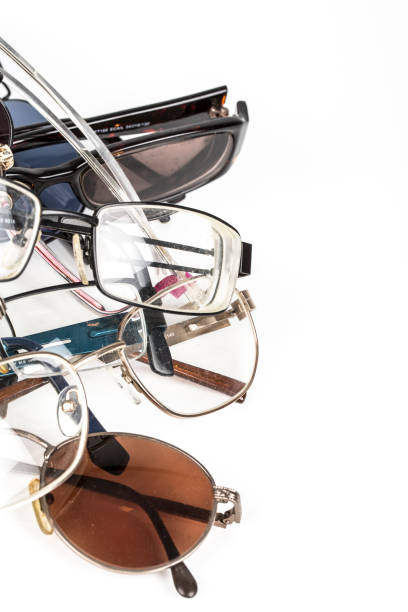 istock Pile of old used eye reading spectacles glasses on a white background. In studio 1037646786