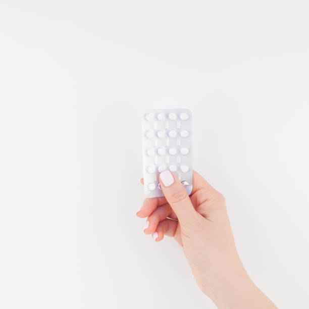 Female hand with pills in blister Woman hand with pastel manicure polish holding pills in blister isolated on white background with copy space. Square Template for feminine beauty blog social media. Female healthcare concept Ovulation stock pictures, royalty-free photos & images