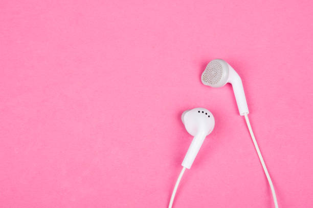 istock White earbud headphones on a pastel pink background, copy space on the left for your text 1037646858