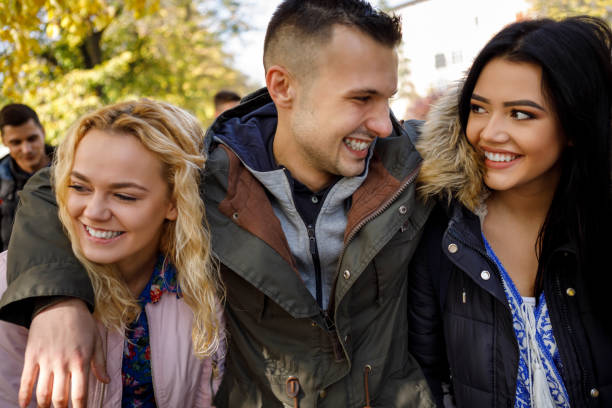 istock Group of college students walking together on university campus 1037655908