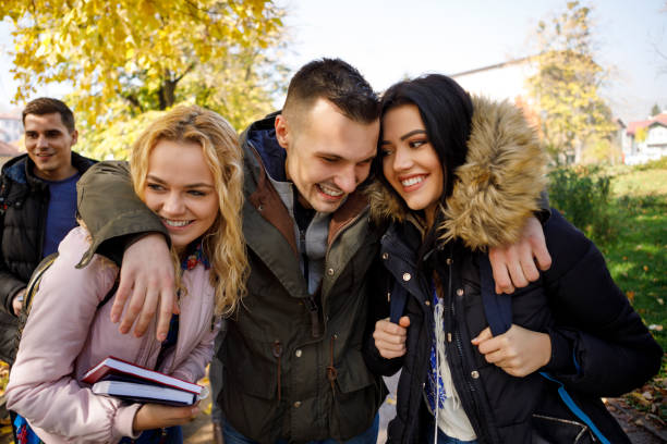istock Group of college students walking together on university campus 1037655916