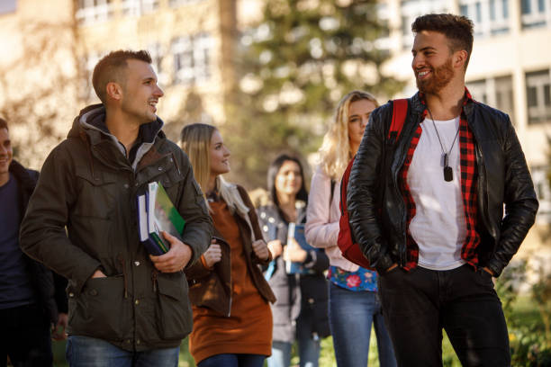 istock Group of college students walking on university campus 1037656634