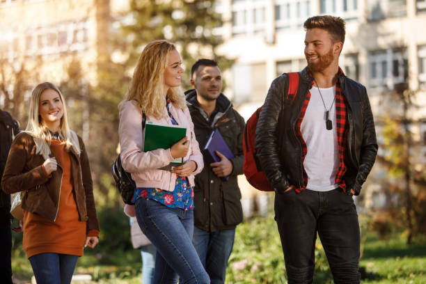 istock Group of college students walking on university campus 1037656694