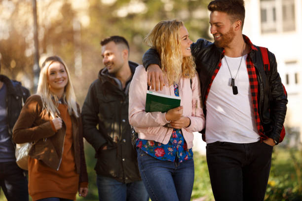 istock Group of college students walking on university campus 1037656726