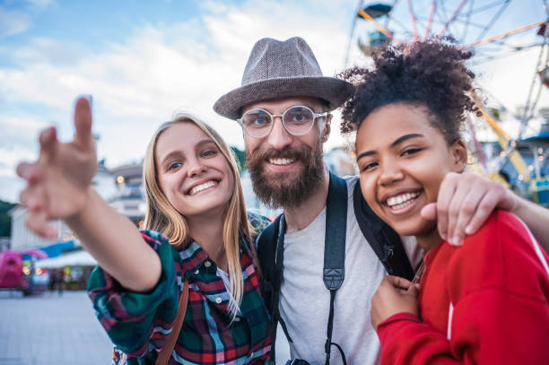 istock cheerful young multiethnic friends smiling at camera in amusement park 1037666136