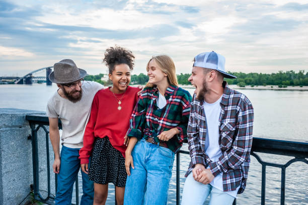 istock cheerful young multiethnic friends spending time together and laughing at riverside 1037670100