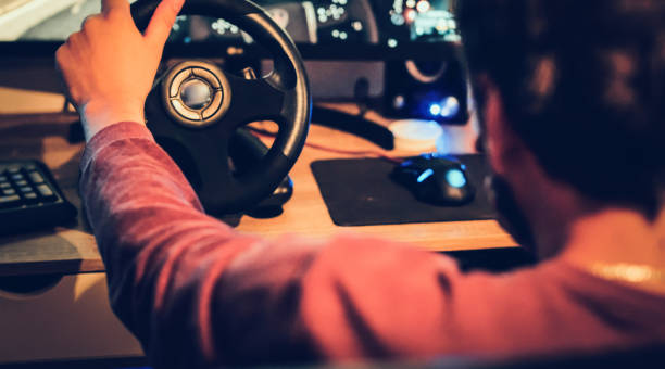 istock Man playing car racing video game at home 1037673270