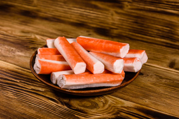istock Ceramic plate with crab sticks on wooden table 1037673564