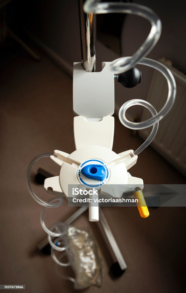 Drip stand organiser for Peritoneal dialysis, with dial switched to the finished position. Bag of fluid is full on the floor. Catheter Stock Photo