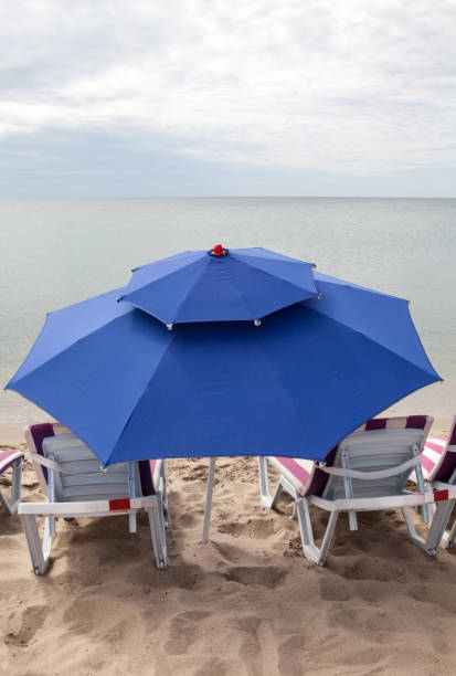 istock Deck chairs and umbrella on the beach 1037674406