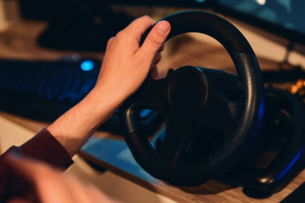 istock Man playing car racing video game at home 1037679836