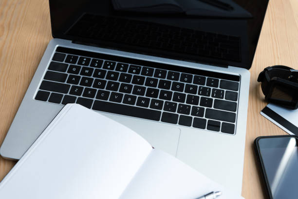 istock laptop, smartwatch, smartphone, credit card and blank notebook on table 1037679896