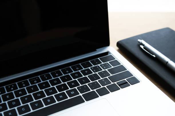 istock close-up view of laptop with blank screen, notebook and pen on table 1037679940