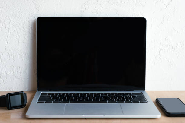 istock laptop with blank screen, smartwatch and smartphone on table 1037679964