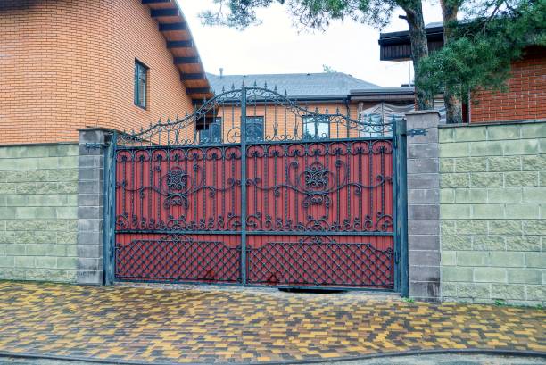 istock red iron gate with a wrought-iron pattern with a stone fence in the street 1037684442