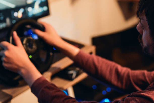 istock Man playing car racing video game at home 1037684538