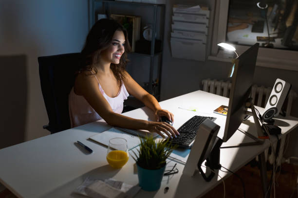 istock Smiling female entrepreneur working from home late at night 1037696852