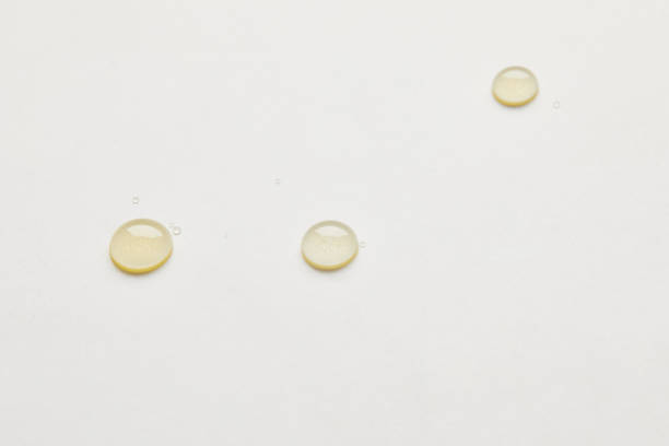 istock close up view of honey drops on white tabletop 1037699394