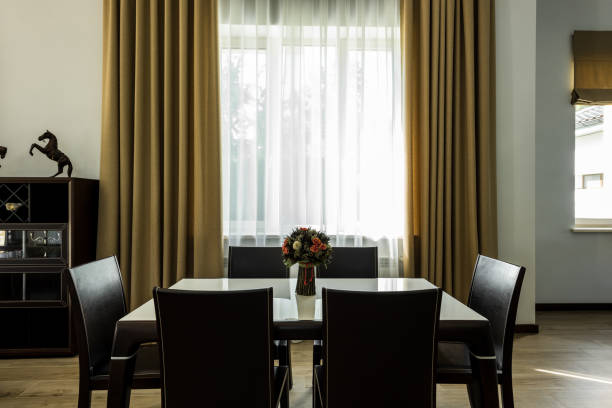 istock interior view of stylish dining room with table, chairs and big window 1037715470