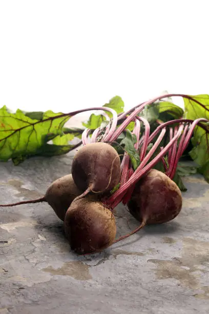 Red Beetroot with herbage green leaves on rustic background. Organic Beetroot.