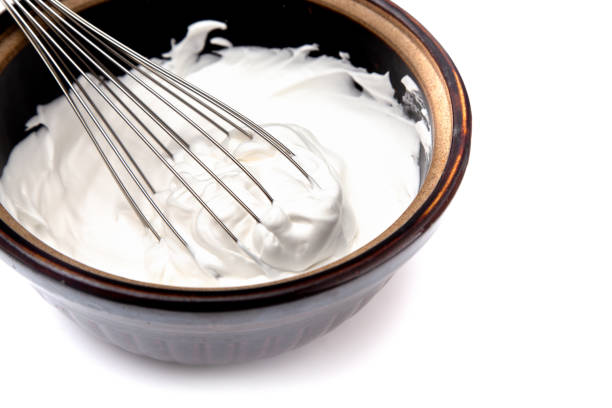 istock Whipped Cream with a Whisk on a White Background 1037732734