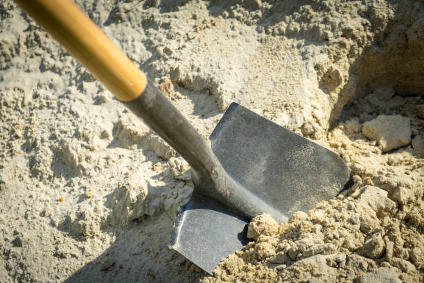 istock Digging sand with a shovel. place for your text. 1037742440