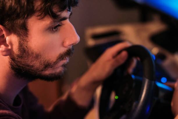 istock Man playing car racing video game at home 1037742820