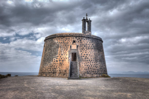 Lanzarote, Spain - September 1, 2018: Cloudscape over Torre del Aguila in Playa Blanca in Lanzarote Island, Canary Islands. It was a defensive point used to protect the island against the pirates