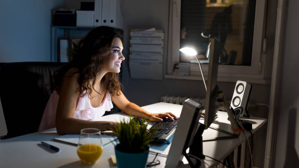 istock Woman working late at night at home 1037744476