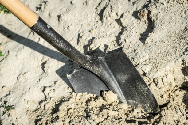 istock Digging sand with a shovel. place for your text. 1037749202