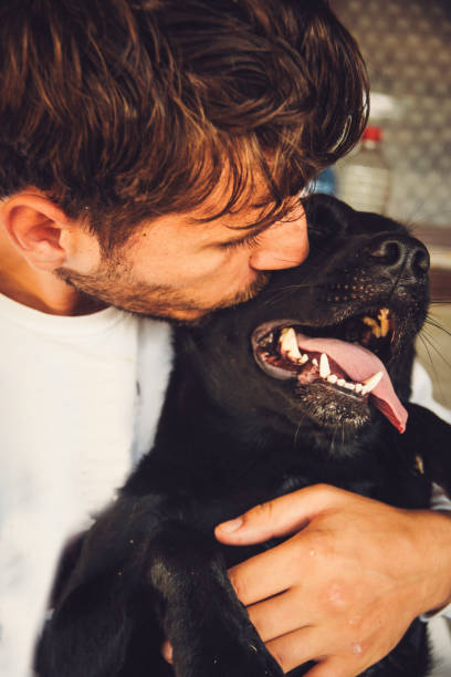 istock Man and dog cuddling 1037783614
