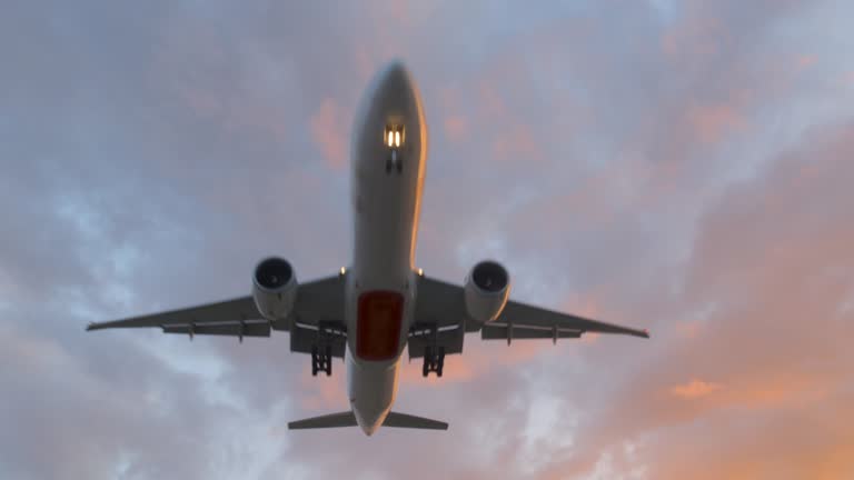 Airplane impressive take off / landing flying overhead at dusk, 4K