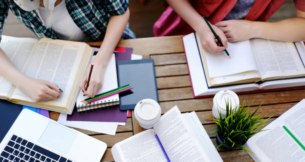 istock Top view of young students with books and notes in cafe 1037793202