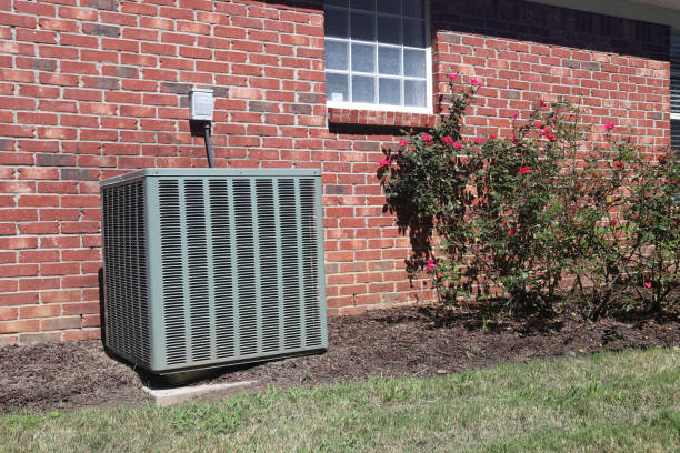 istock Air conditioner system next to home with brick wall. 1037795098