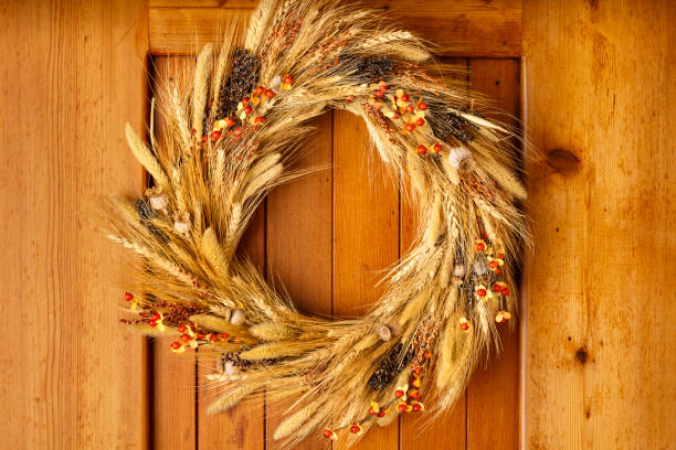 istock House home front door Fall autumn Thanksgiving decorations country style rustic wreath made of natural botanical materials on wood background 1037797642