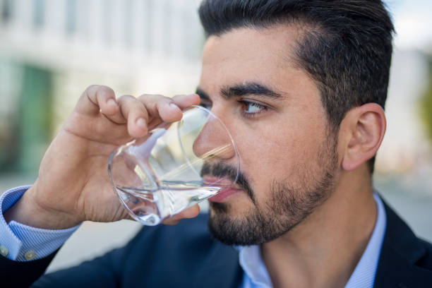 istock Handsome young businessman drinking water on break 1037820522